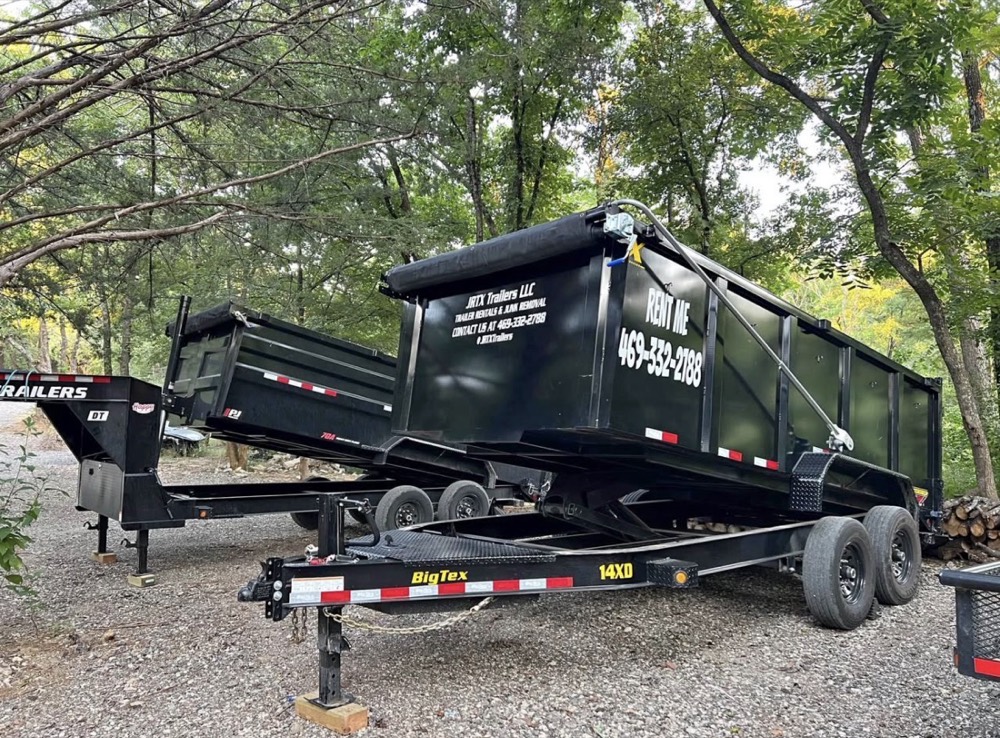 JRTX Trailers 15-yard dump trailer parked on gravel, gate down